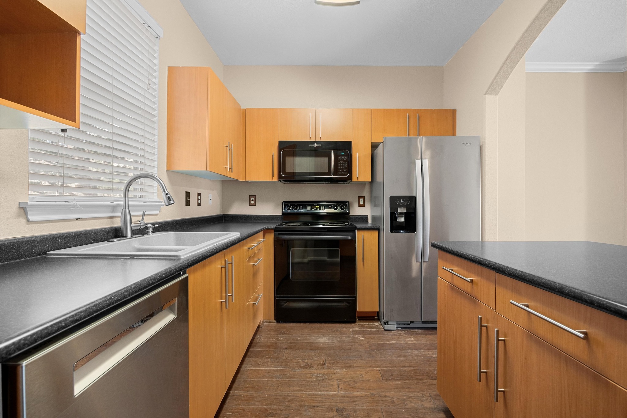 11203 Ranch Road 2222, Unit 1105 Austin, TX 78730 - Photo 10 of 35 Kitchen with black appliances, dark countertops, and dark wood-style floors