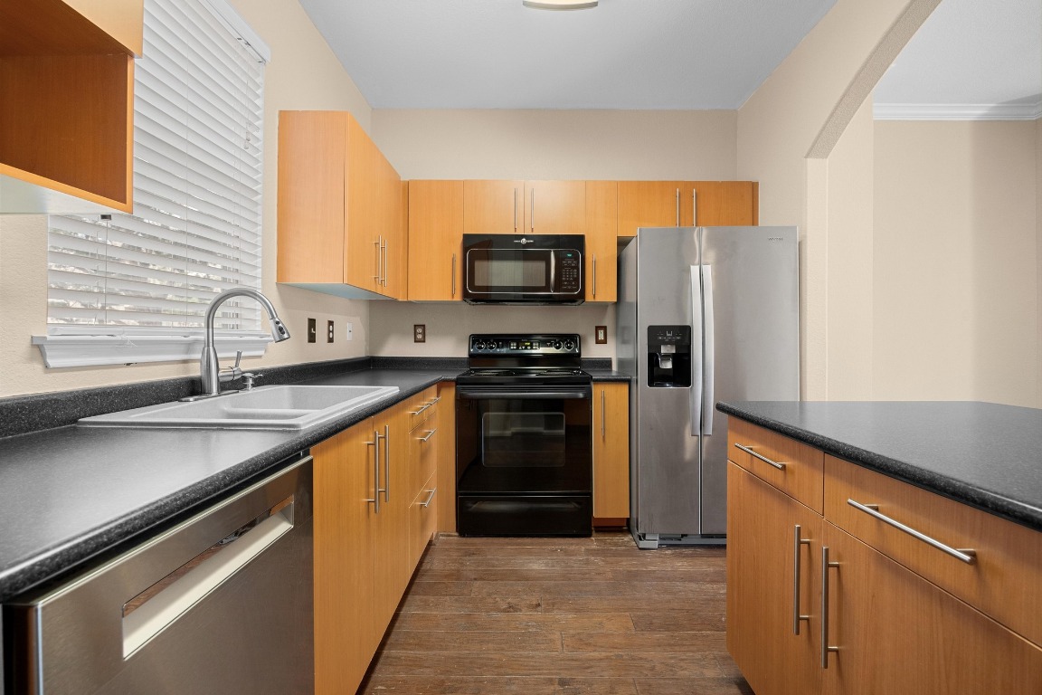 11203 Ranch Road 2222, Unit 1105 Austin, TX 78730 - Photo 10 of 35 a kitchen with stainless steel appliances a stove sink and microwave