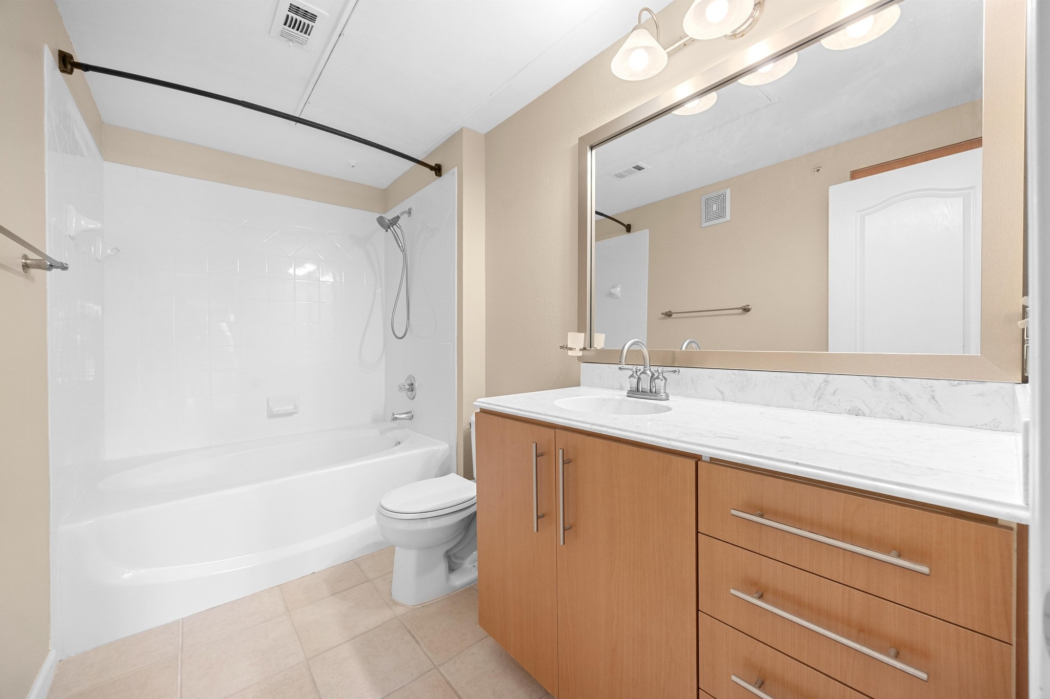 11203 Ranch Road 2222, Unit 1105 Austin, TX 78730 - Photo 14 of 35 Full bath with vanity, shower / bath combination, and light tile patterned floors