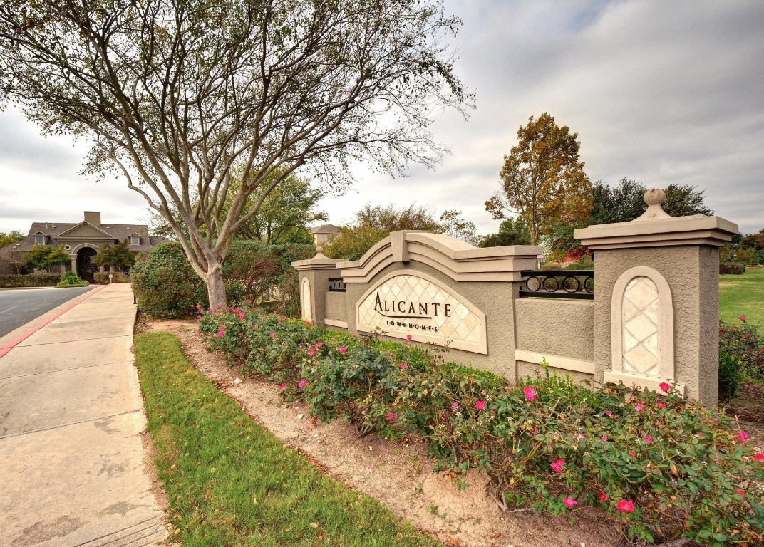 11203 Ranch Road 2222, Unit 1105 Austin, TX 78730 - Photo 29 of 35 a view of a street sign under a large tree