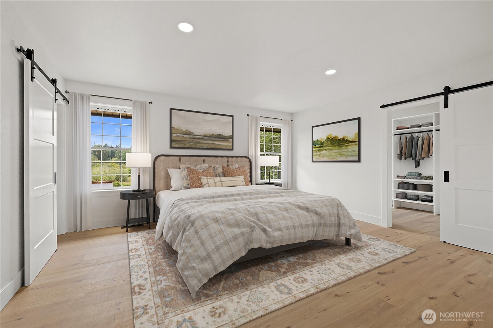 25106 47th Avenue Northeast Arlington, WA 98223 - Photo 12 of 30 a bedroom with a large bed and a flat tv screen on dresser