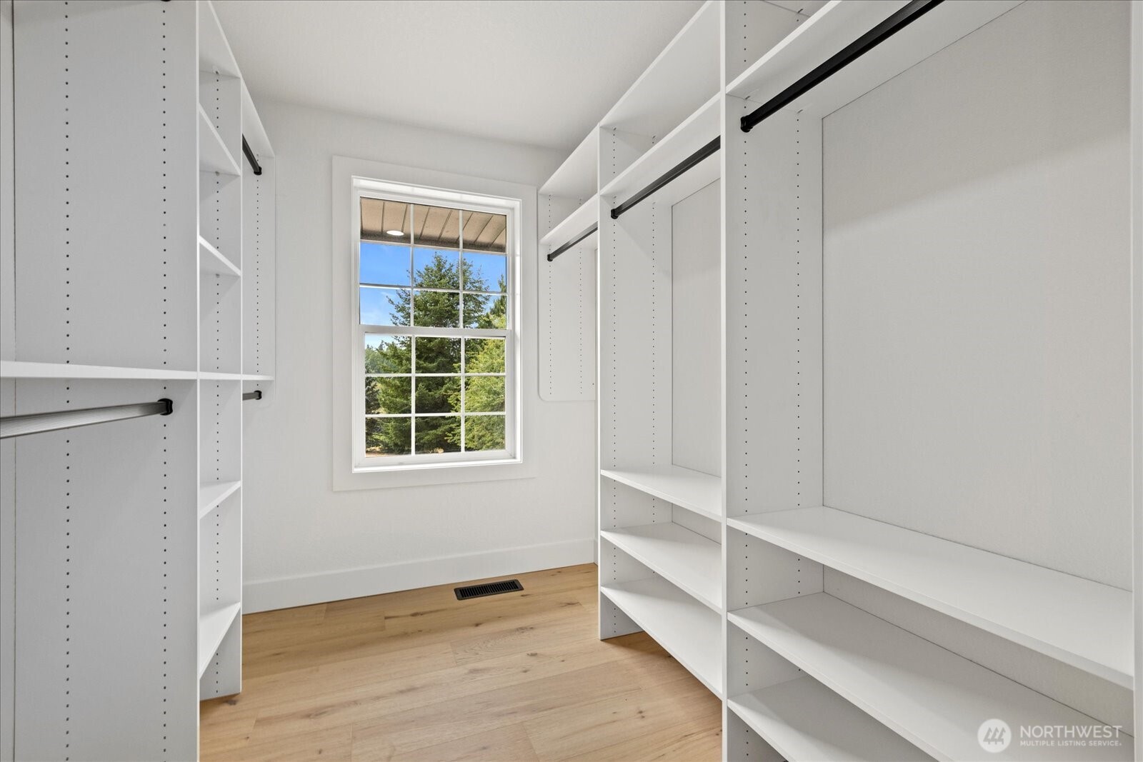 25106 47th Avenue Northeast Arlington, WA 98223 - Photo 16 of 30 a view of an empty room with wooden floor and a window