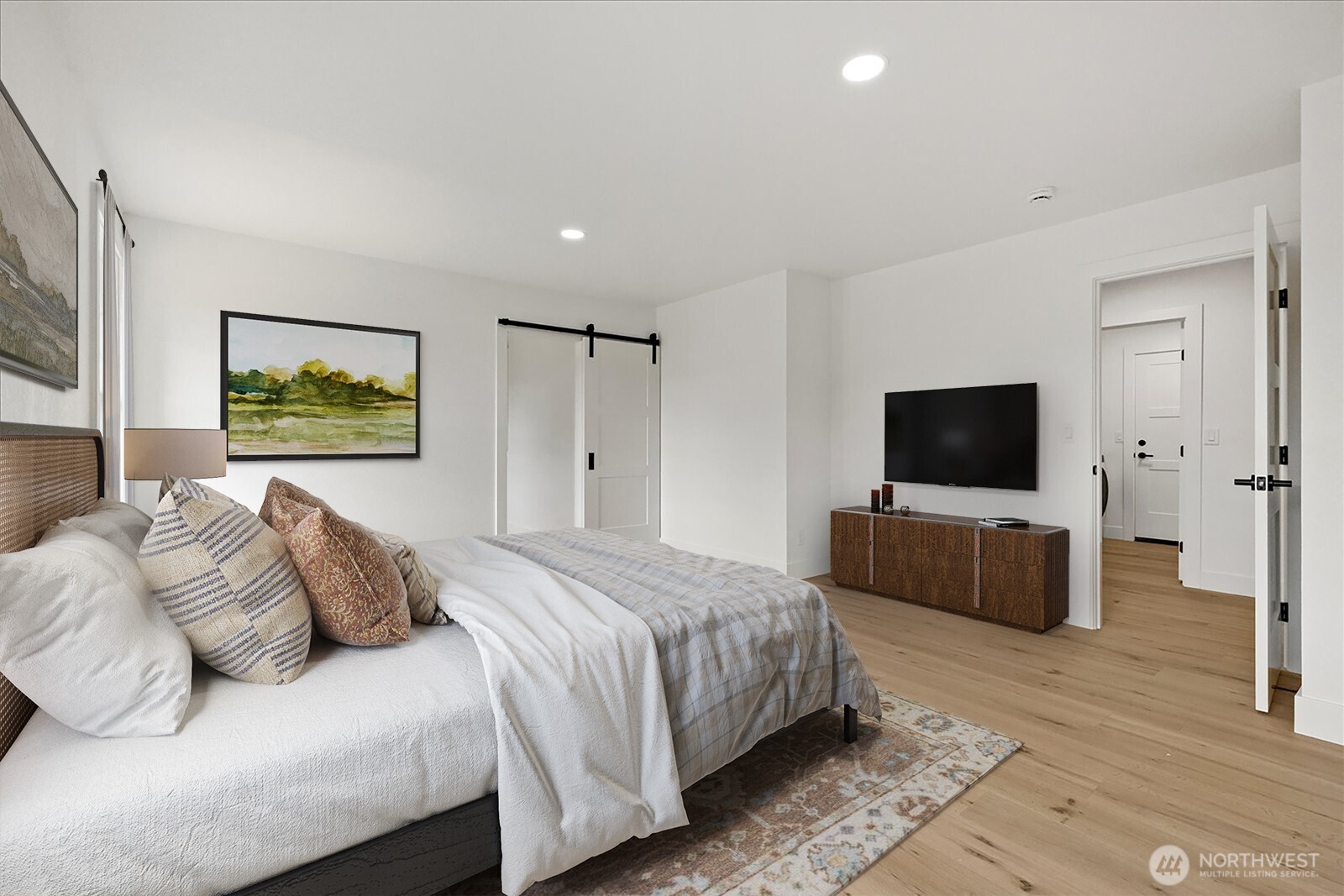 25106 47th Avenue Northeast Arlington, WA 98223 - Photo 17 of 30 a bedroom with a bed and a flat screen television