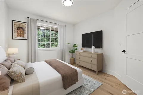 a bedroom with a bed and a flat screen tv