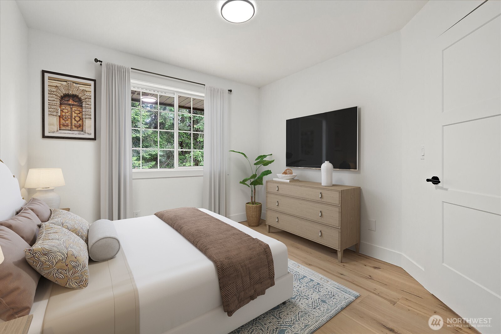 25106 47th Avenue Northeast Arlington, WA 98223 - Photo 19 of 30 a bedroom with a bed and a flat screen tv