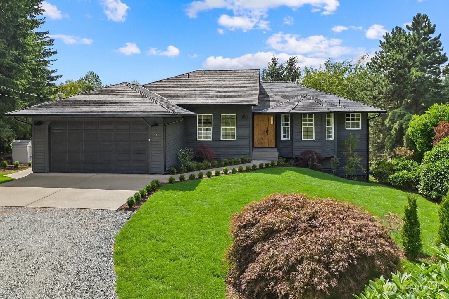 25106 47th Avenue Northeast Arlington, WA 98223 - Photo 2 of 30 a front view of a house with a garden