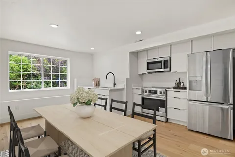 a view of a dining room with furniture window and wooden floor