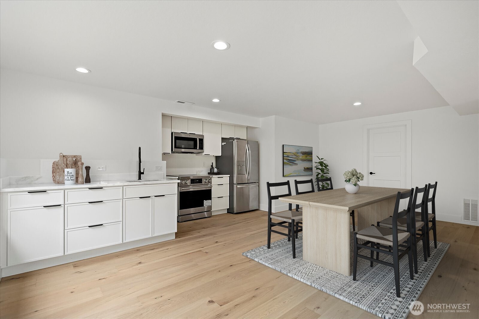 25106 47th Avenue Northeast Arlington, WA 98223 - Photo 22 of 30 a kitchen with white cabinets and stainless steel appliances