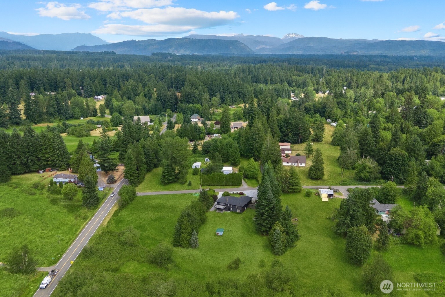 25106 47th Avenue Northeast Arlington, WA 98223 - Photo 30 of 30 a view of a lush green hillside and houses