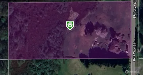 a view of swimming pool with lawn chairs and plants