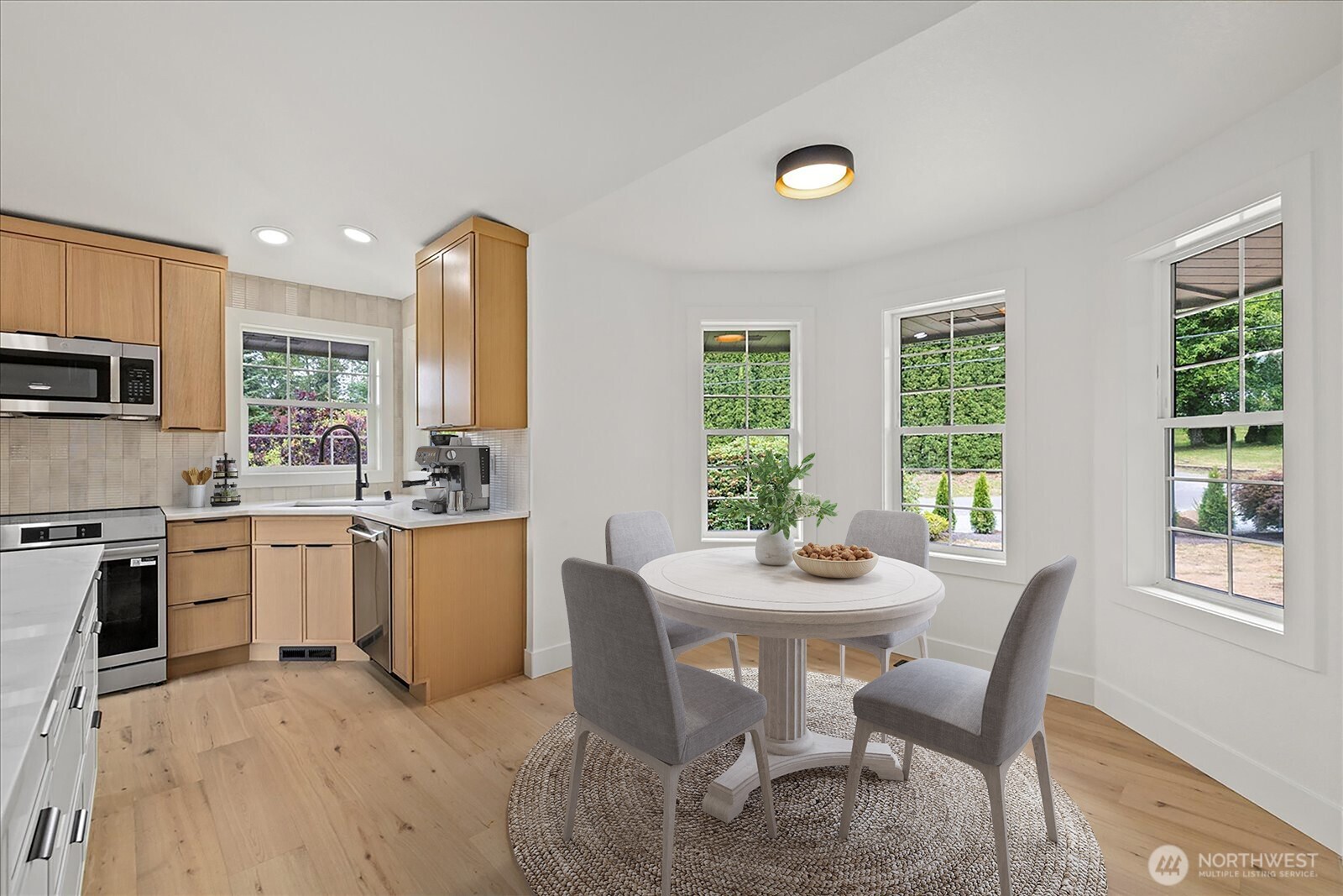 25106 47th Avenue Northeast Arlington, WA 98223 - Photo 9 of 30 a kitchen with a table chairs sink and microwave
