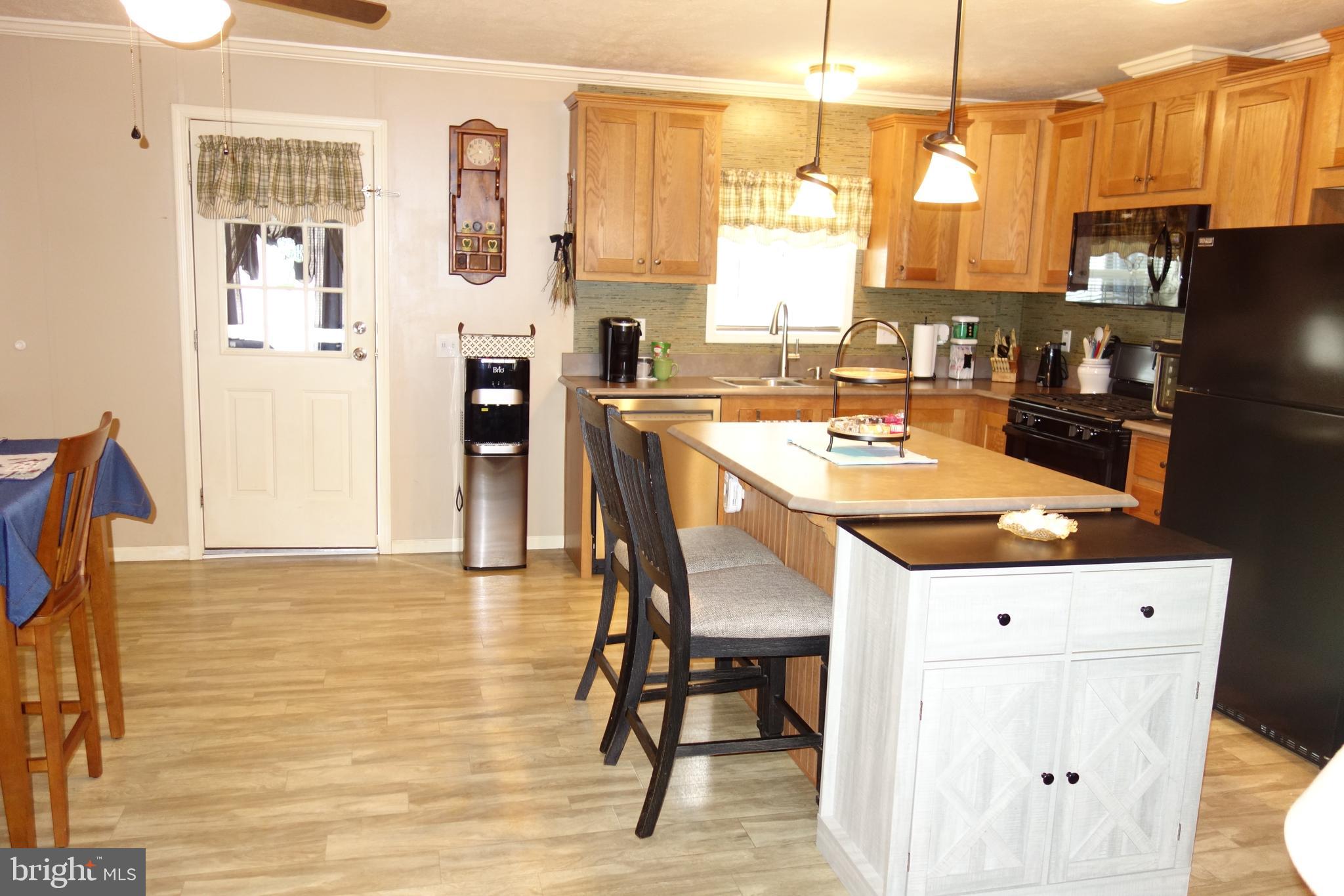 106 Circle Drive Nottingham, PA 19362 - Photo 5 of 16 a kitchen with stainless steel appliances kitchen island granite countertop a refrigerator a stove and white cabinets with wooden floor