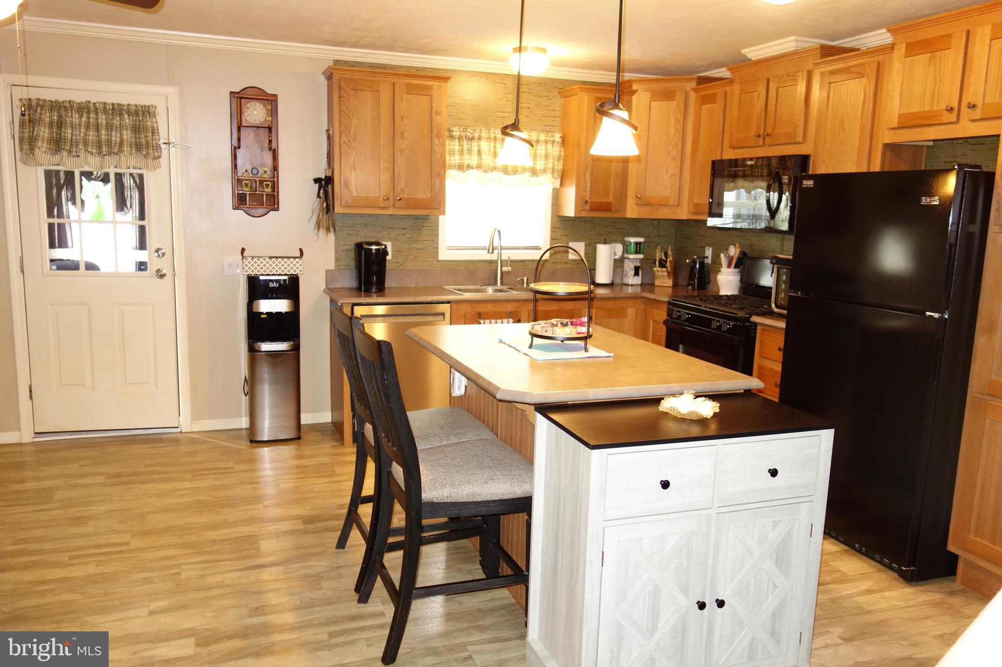 106 Circle Drive Nottingham, PA 19362 - Photo 6 of 16 a kitchen with stainless steel appliances kitchen island granite countertop a refrigerator a stove top oven a sink and dining table with wooden floor