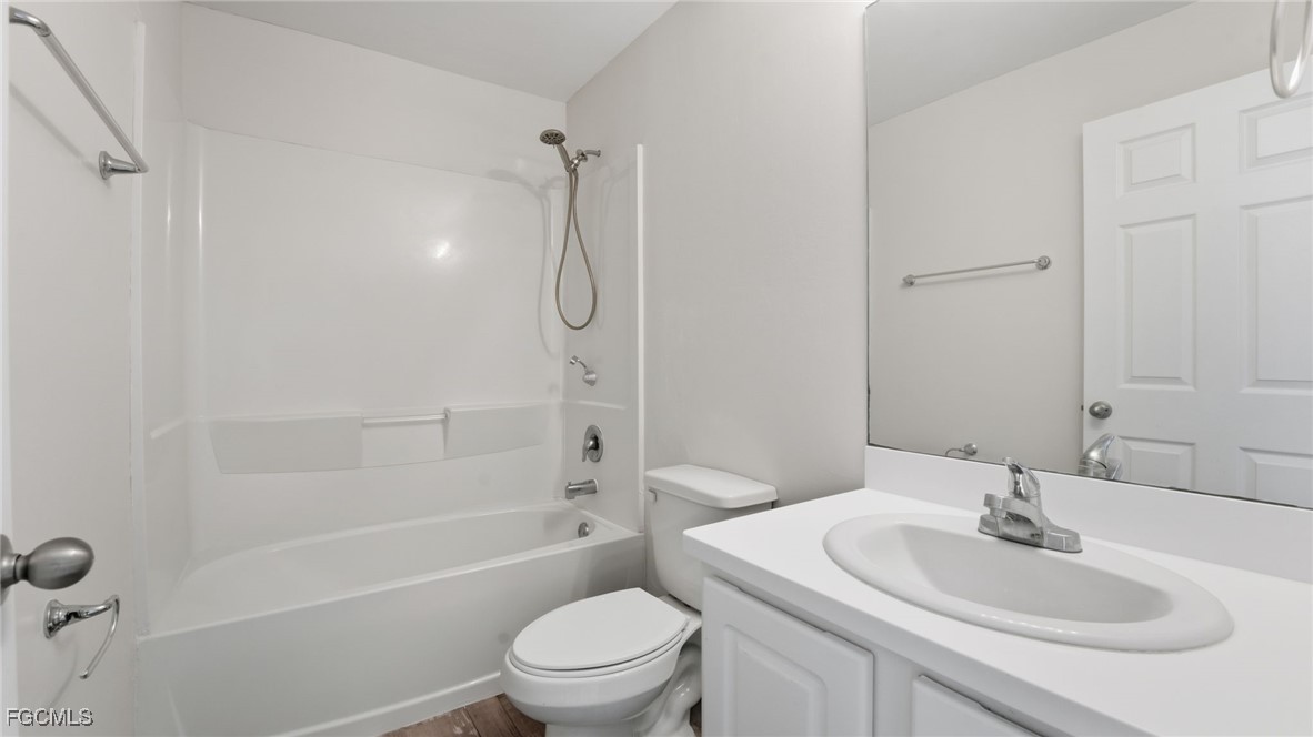 2701 East 18th Street Lehigh Acres, FL 33972 - Photo 19 of 24 a bathroom with a sink toilet and shower