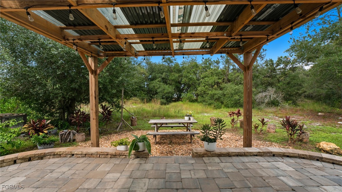2701 East 18th Street Lehigh Acres, FL 33972 - Photo 2 of 24 a view of a porch with furniture and a yard