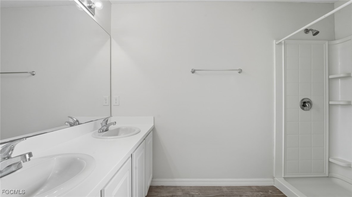 2701 East 18th Street Lehigh Acres, FL 33972 - Photo 21 of 24 a bathroom with a sink and a mirror