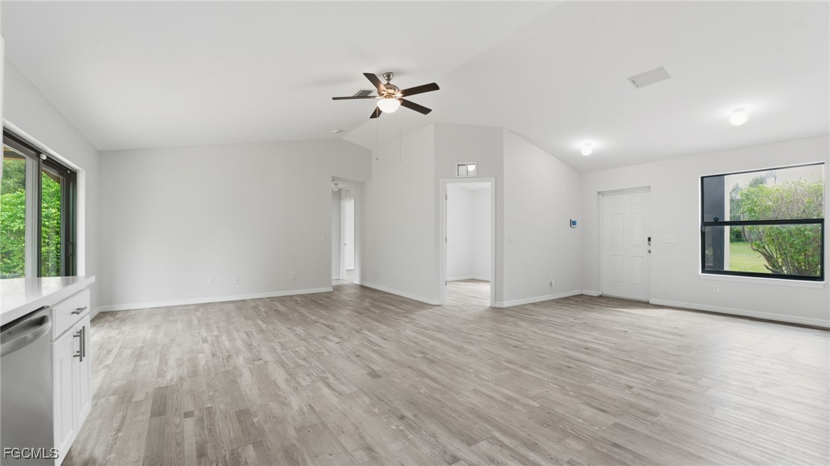 2701 East 18th Street Lehigh Acres, FL 33972 - Photo 7 of 24 wooden floor in an empty room with a window