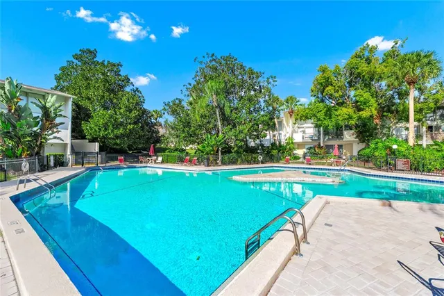 an aerial view of lake and residential houses with outdoor space