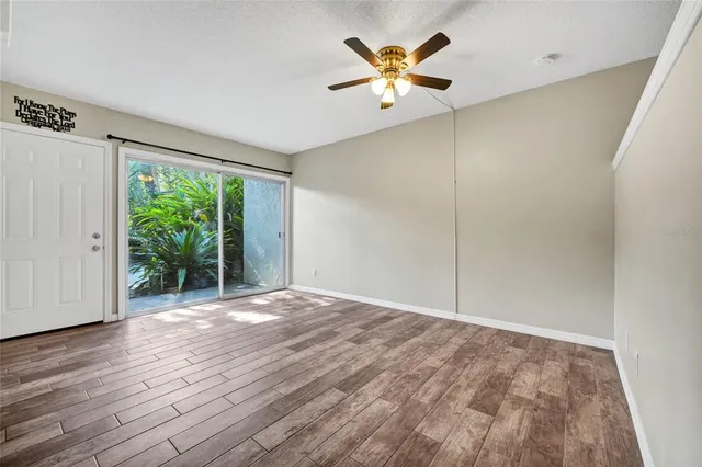 a view of a room with wooden floor and a window