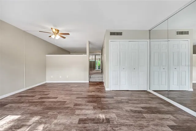 a living room with furniture a flat screen tv and a large window