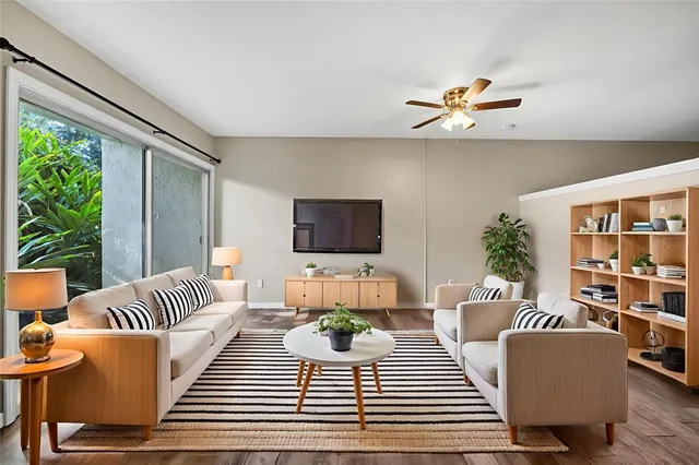 a view of a big room with wooden floor and windows