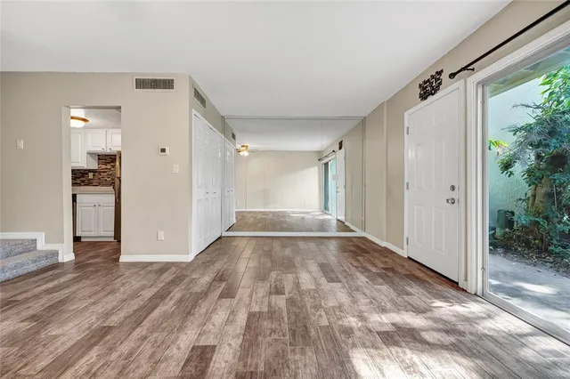 an empty room with closet and a fireplace