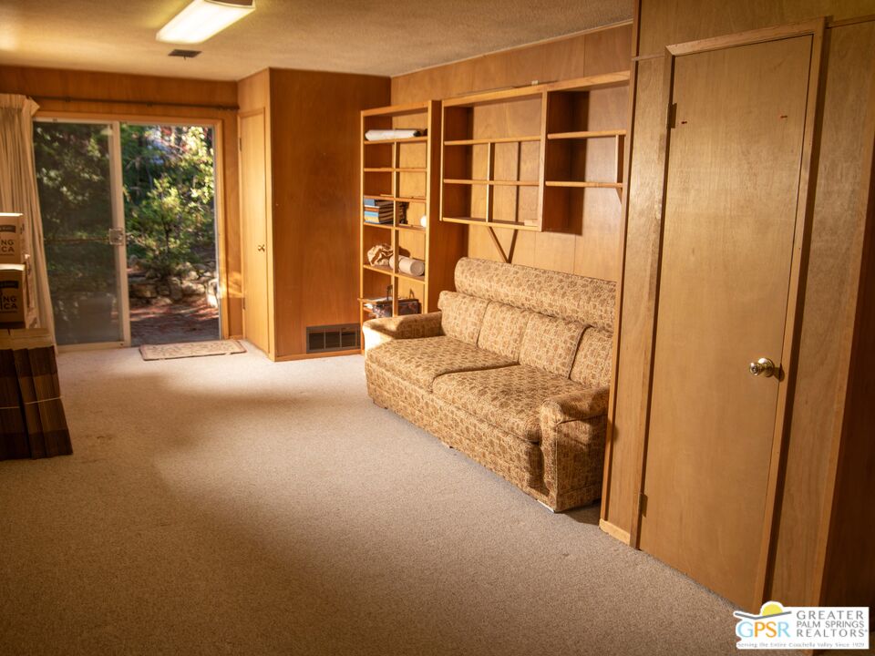 25970 Cedar Street Idyllwild, CA 92549 - Photo 9 of 27 a living room with a bed and large window