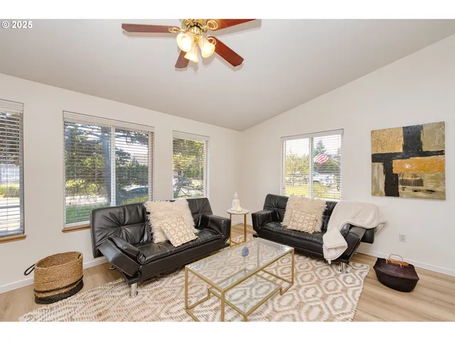 a living room with furniture a rug and a large window