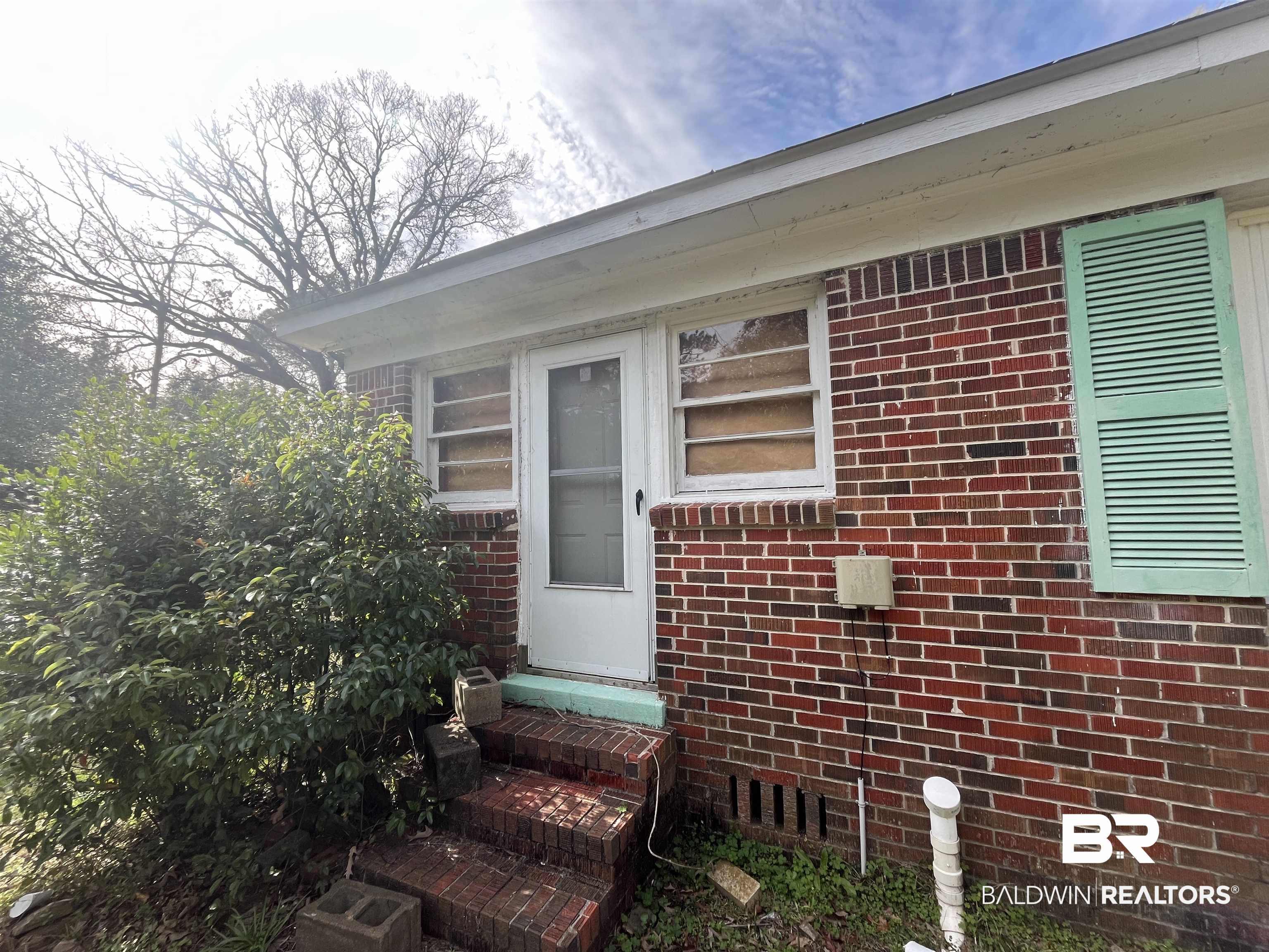 5055 Overlook Road Mobile, AL 36618 - Photo 16 of 28 View of exterior entry featuring brick siding