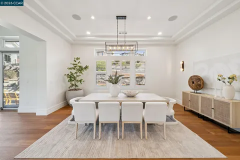 a view of a dining room with furniture wooden floor and chandelier