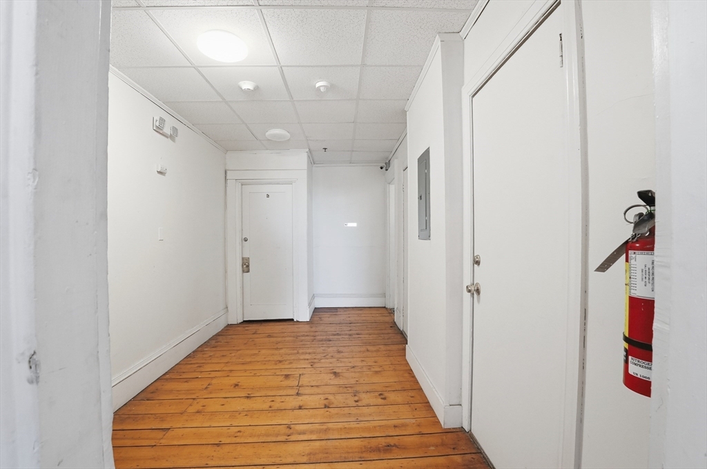 621 2nd Street Fall River, MA 02721 - Photo 11 of 42 a view of a hallway with wooden floor