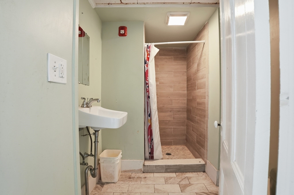 621 2nd Street Fall River, MA 02721 - Photo 12 of 42 a bathroom with a shower and a sink
