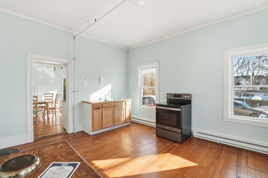 621 2nd Street Fall River, MA 02721 - Photo 25 of 42 a living room with furniture and a kitchen