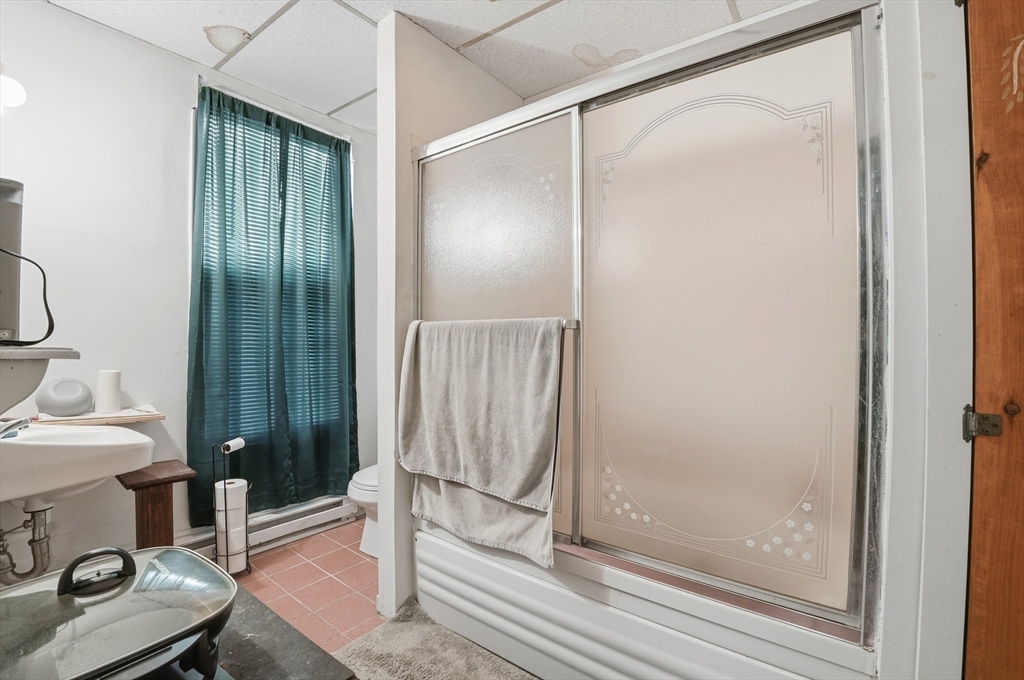 621 2nd Street Fall River, MA 02721 - Photo 36 of 42 a bathroom with a mirror and a shower