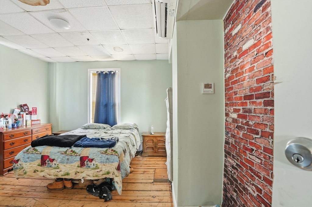 621 2nd Street Fall River, MA 02721 - Photo 37 of 42 a bedroom with a bed and a painting on the wall
