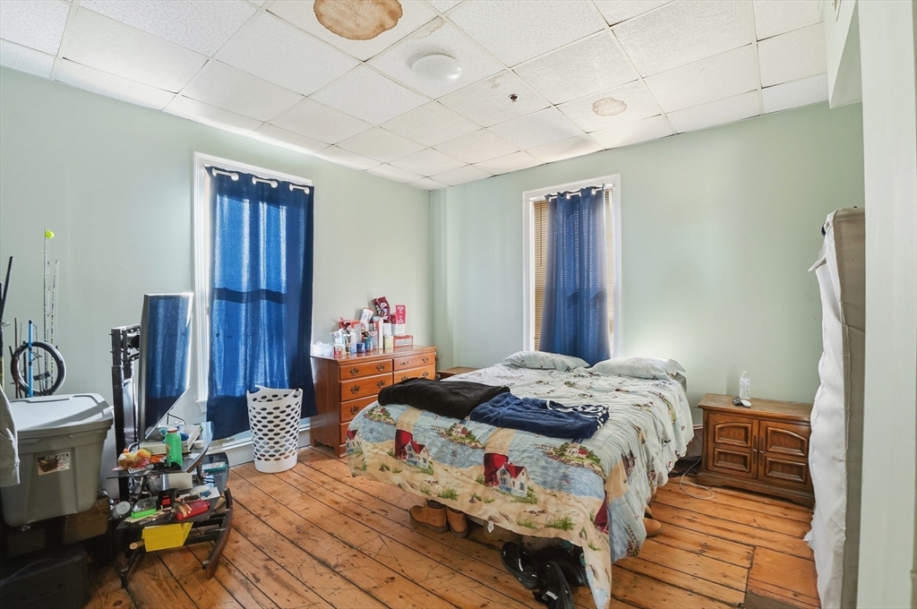 621 2nd Street Fall River, MA 02721 - Photo 38 of 42 a bedroom with a bed and wooden floor