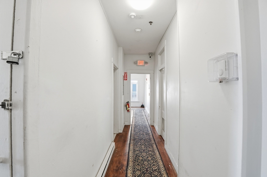 621 2nd Street Fall River, MA 02721 - Photo 9 of 42 a view of hallway with closet and wooden floor
