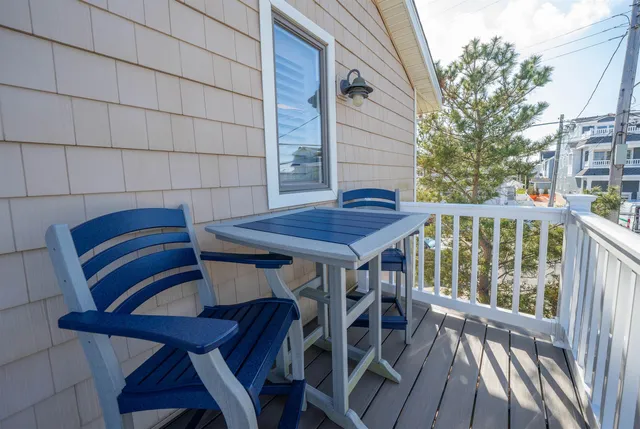 a view of balcony with wooden floor and outdoor seating
