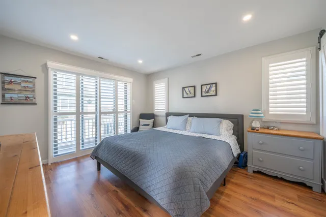 a spacious bedroom with a large bed and a large window