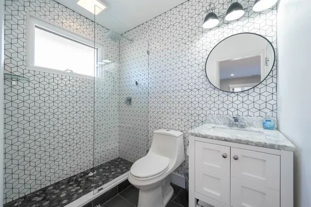 a bathroom with a sink toilet and a mirror