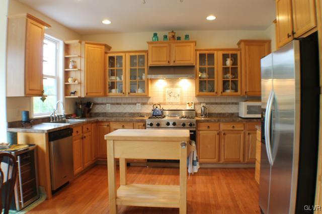 2825 County Line Road Riegelsville, PA 18077 - Photo 6 of 40 a kitchen with stainless steel appliances granite countertop a refrigerator a sink a stove and a microwave