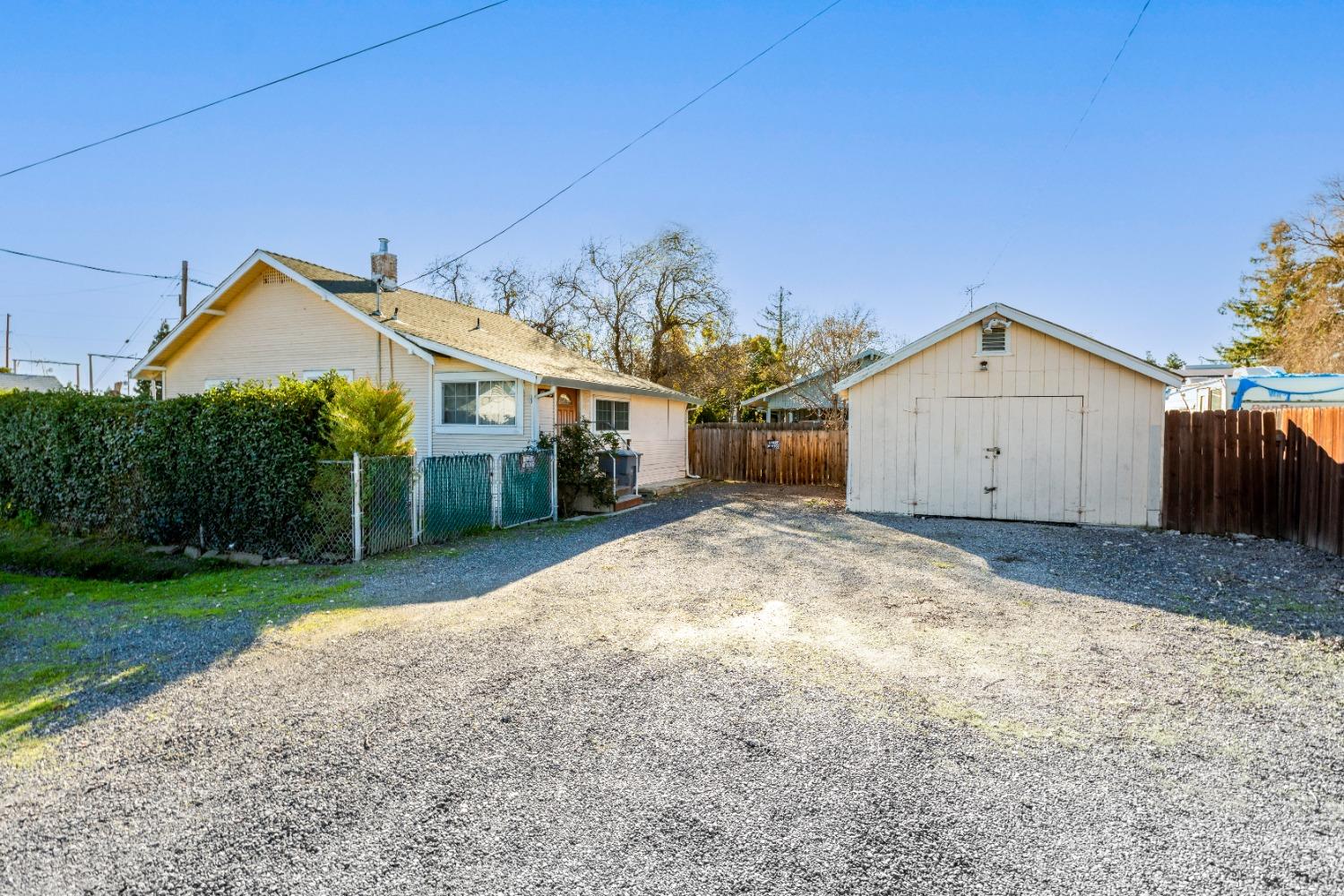 1174 5th Street Meridian, CA 95957 - Photo 1 of 1 a view of a house with a yard and garage