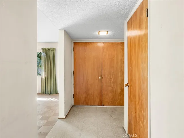an empty room with windows and closet