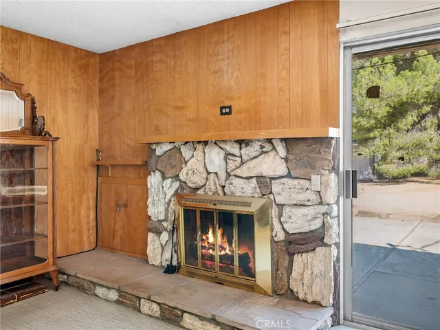 a living room with furniture a fireplace and gym equipment