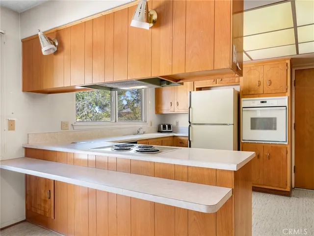 a kitchen that has a sink and a stove
