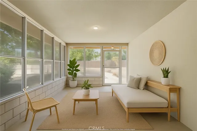 an empty room with windows front door