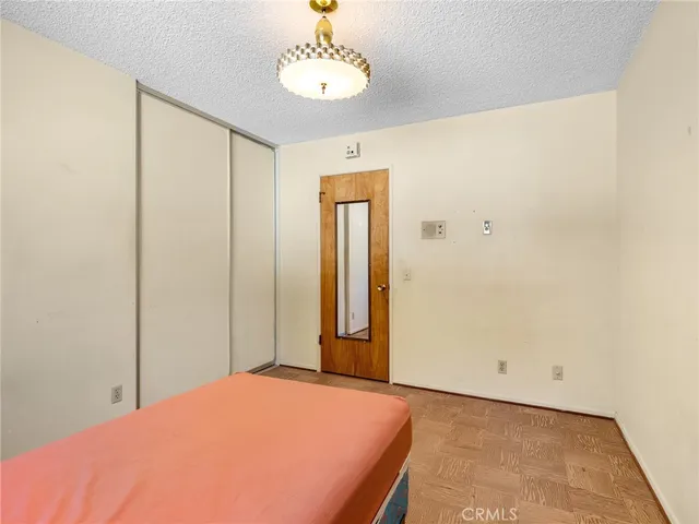 a bedroom with a bed and painting on the wall