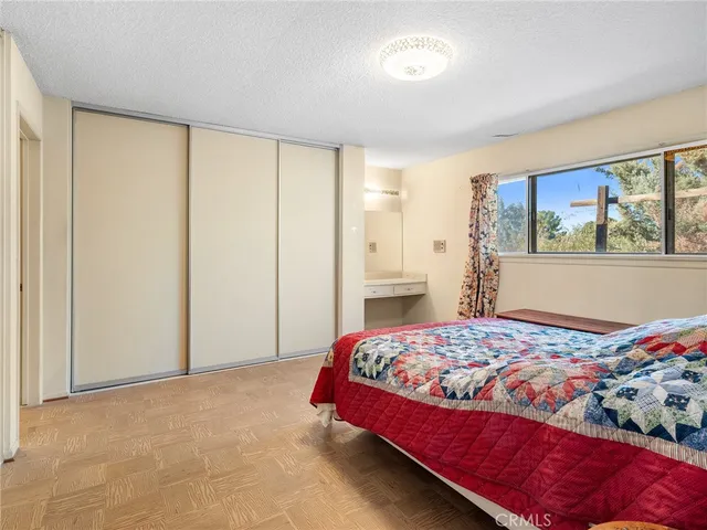 a bedroom with a bed and a lamp