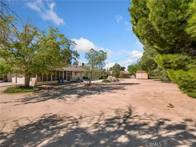 a view of a house with a tree and a yard