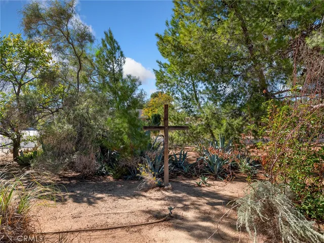a view of a patio with table and chairs and potted plants